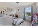 Bright bedroom features a window, playful decor, and comfortable bed at 632 Albermarle Dr, Pittsboro, IN 46167