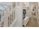Bright hallway with white trim, carpeted stairs, and built in storage with coat hooks at 632 Albermarle Dr, Pittsboro, IN 46167