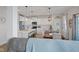 Bright open kitchen features white cabinets, stainless appliances, and island with barstool seating at 632 Albermarle Dr, Pittsboro, IN 46167