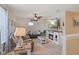 Comfortable living room with fireplace, ceiling fan, and plush seating area at 632 Albermarle Dr, Pittsboro, IN 46167