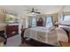 Spacious main bedroom with a fireplace, TV, ceiling fan, and large windows at 632 Albermarle Dr, Pittsboro, IN 46167