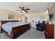 Spacious main bedroom featuring a ceiling fan, TV, and a relaxing chair at 632 Albermarle Dr, Pittsboro, IN 46167