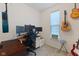 Home office featuring a large desk setup, multiple monitors, and guitar decor at 632 Albermarle Dr, Pittsboro, IN 46167