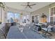 Enclosed sunroom with ceiling fan and patio furniture seating six people at 632 Albermarle Dr, Pittsboro, IN 46167