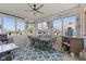 Inviting sunroom with casual seating, ceiling fan and view of backyard at 632 Albermarle Dr, Pittsboro, IN 46167