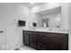Bathroom featuring dual sinks, dark cabinets, light quartz countertop, and modern fixtures at 6507 W Whispering Way, Greenfield, IN 46140