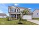 Charming two-story home with a well-manicured lawn and a two-car garage at 6507 W Whispering Way, Greenfield, IN 46140