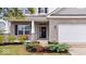 Inviting front porch with brick accents and well-maintained landscaping at 6507 W Whispering Way, Greenfield, IN 46140