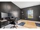 Home office with dark accent wall, carpeted floors, and natural light from the window at 6507 W Whispering Way, Greenfield, IN 46140