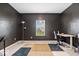 Spacious home office featuring large window, a desk, a carpeted floor and black accent wall at 6507 W Whispering Way, Greenfield, IN 46140