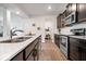 Modern kitchen featuring stainless steel appliances, quartz countertops, and ample cabinet space at 6507 W Whispering Way, Greenfield, IN 46140