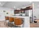 Modern kitchen featuring stainless steel appliances, a breakfast bar, and sleek countertops at 6507 W Whispering Way, Greenfield, IN 46140