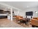 Open-concept living room and kitchen layout with wood floors and modern decor at 6507 W Whispering Way, Greenfield, IN 46140