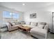 Cozy living room featuring a large sectional sofa, area rug, and a natural light-filled window at 6507 W Whispering Way, Greenfield, IN 46140