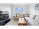 Relaxing living room features a sectional sofa, decorative pillows, and a TV with sleek console at 6507 W Whispering Way, Greenfield, IN 46140