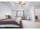 Spacious main bedroom with neutral tones, tray ceilings and a window with natural light at 6507 W Whispering Way, Greenfield, IN 46140