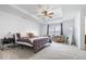 Serene main bedroom with tray ceiling, neutral carpet, and stylish furnishings and decor at 6507 W Whispering Way, Greenfield, IN 46140