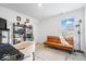 Bright office space with modern décor, including a convertible sofa and bookcase, perfect for working from home at 6507 W Whispering Way, Greenfield, IN 46140