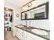 Bright bathroom with double sinks, large vanity mirror, and open walk-in closet at 6580 Kings Ct, Avon, IN 46123