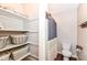 Bright bathroom featuring a shower with modern fixtures, a toilet, and convenient built-in shelving for storage at 6580 Kings Ct, Avon, IN 46123