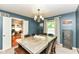 Lovely dining room featuring a modern chandelier, wooden table, and calming blue walls at 6580 Kings Ct, Avon, IN 46123