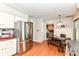 Kitchen includes stainless appliances, white cabinets, wood floors, and an eat-in dining area at 6580 Kings Ct, Avon, IN 46123