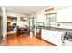 Eat-in kitchen features stainless appliances, white cabinets, and a view into the living room and backyard at 6580 Kings Ct, Avon, IN 46123