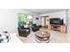 Cozy living room features two studded club chairs, a rustic round coffee table, and a large window at 6580 Kings Ct, Avon, IN 46123
