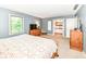 This tranquil primary bedroom features a large window, wooden furniture, and an en suite bathroom at 6580 Kings Ct, Avon, IN 46123