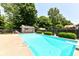 Sparkling swimming pool with clean, clear water with ladder and diving board and a pool house in the background at 6580 Kings Ct, Avon, IN 46123
