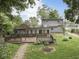 View of the backyard featuring a wooden deck and fire pit at 70 Fairground St, Franklin, IN 46131