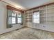 Cozy room with built-in shelving, cabinets, paneled walls, large windows, and carpet at 70 Fairground St, Franklin, IN 46131