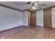 A bedroom featuring hardwood floors, white walls with trim, and a ceiling fan at 70 Fairground St, Franklin, IN 46131
