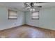 Bedroom with hardwood floors, two windows with blinds, and ceiling fan at 70 Fairground St, Franklin, IN 46131