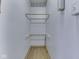 Small closet with a light, wooden racks, and flooring at 70 Fairground St, Franklin, IN 46131