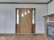 Entryway featuring a wooden door with sidelights and a fireplace at 70 Fairground St, Franklin, IN 46131