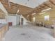 This large garage interior features a staircase to the second floor, cabinets, and fluorescent lighting at 70 Fairground St, Franklin, IN 46131