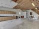This large garage interior features a staircase to the second floor, cabinets, and fluorescent lighting at 70 Fairground St, Franklin, IN 46131