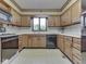 Kitchen features oak cabinets, appliances, and a window at 70 Fairground St, Franklin, IN 46131