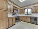 Kitchen with oak cabinets, black appliances, and a window at 70 Fairground St, Franklin, IN 46131