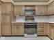 Kitchen features oak cabinets and black appliances at 70 Fairground St, Franklin, IN 46131