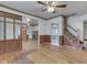 Large living room showcasing wood floors, staircase and built-in wall cabinet at 70 Fairground St, Franklin, IN 46131
