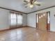 Bright living room with hardwood floors, a ceiling fan, and a wooden front door at 70 Fairground St, Franklin, IN 46131