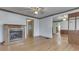 Spacious living room with hardwood floors, a fireplace, ceiling fan, and wood-trimmed walls at 70 Fairground St, Franklin, IN 46131
