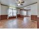 Well-lit living room with hardwood floors, lace curtains and a wooden dividing screen at 70 Fairground St, Franklin, IN 46131