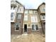 A beautiful new build townhome with brick and siding, and white trim on a cloudy day at 7317 Bayview Run, McCordsville, IN 46055