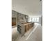 Open-concept kitchen with gray cabinets, an island being constructed, and large windows at 7317 Bayview Run, McCordsville, IN 46055