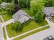 Aerial view of a well-maintained home with a spacious yard, mature trees, and a concrete driveway at 7402 Northfield Blvd, Fishers, IN 46038