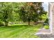 Expansive backyard featuring mature trees, a well-manicured lawn, and a privacy fence at 7402 Northfield Blvd, Fishers, IN 46038
