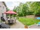 Inviting backyard featuring an outdoor dining area, lush lawn, and a charming picket fence at 7402 Northfield Blvd, Fishers, IN 46038